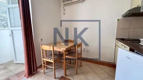 Small kitchen with a dining table and access to the terrace. - image 4