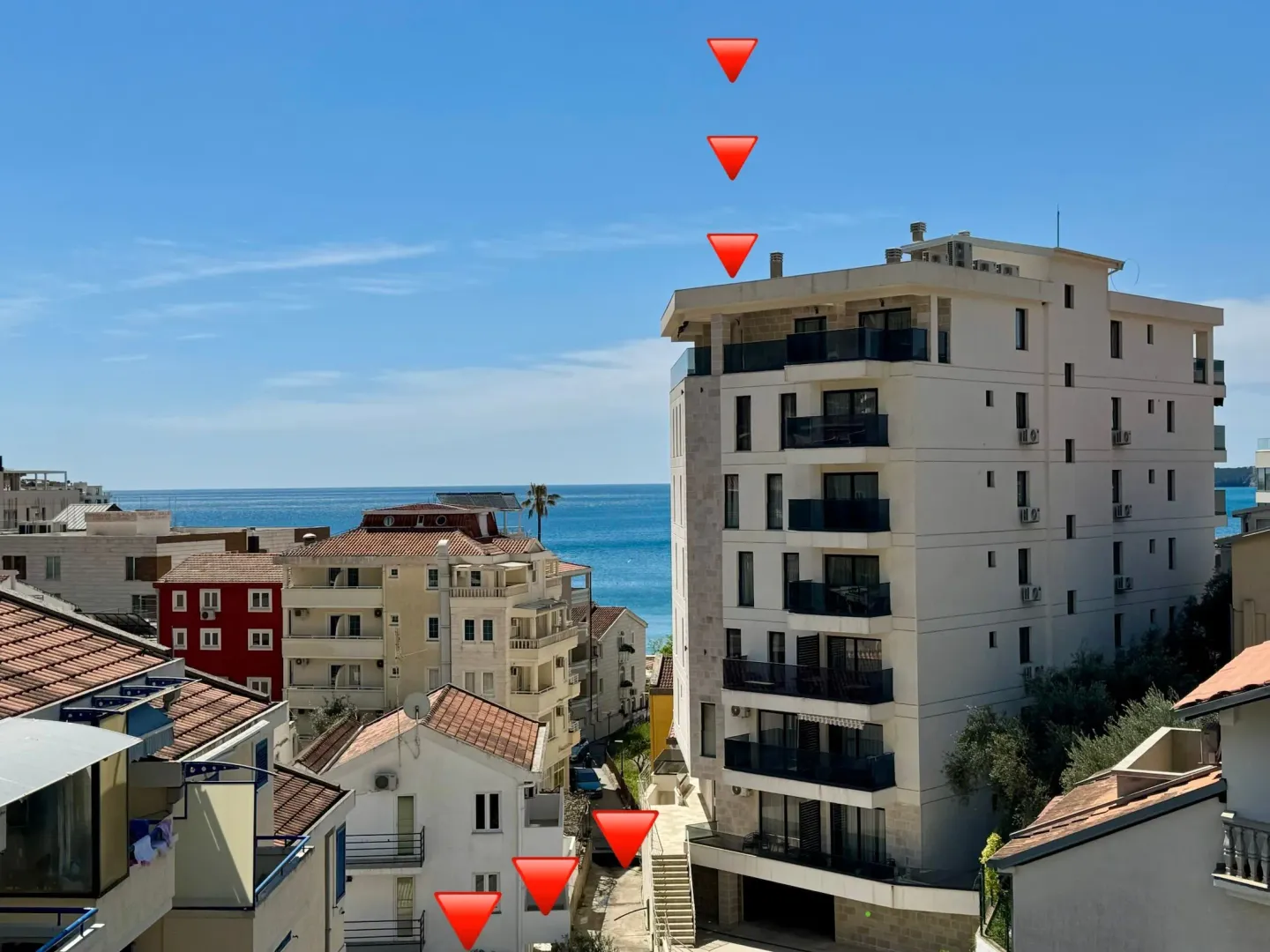 View of buildings and the sea with indicated direction.