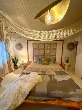 Furnished bedroom with a double bed and decorative elements on the ceiling. - image 7