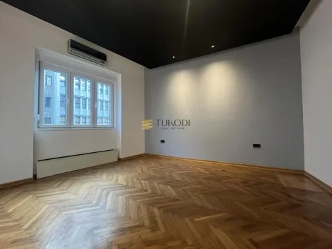 Empty room with parquet flooring and an air conditioning unit. - image 9