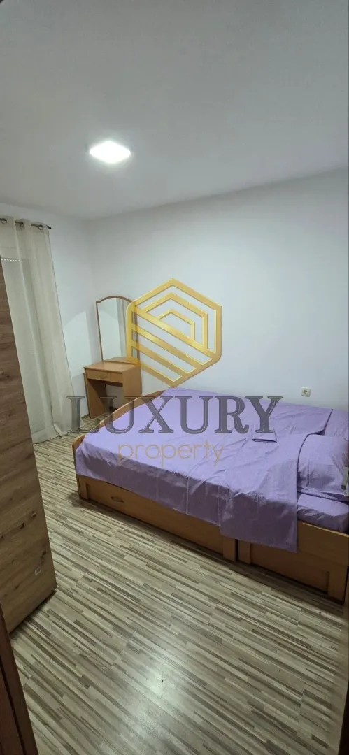 Furnished bedroom with a double bed and wardrobe.