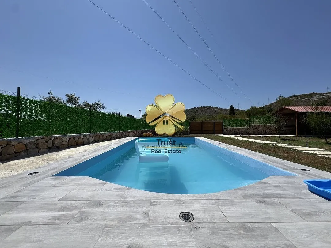Yard with a swimming pool and paved patio.