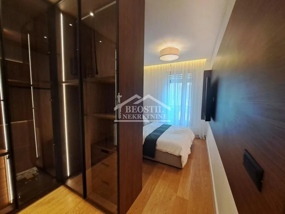 Modern bedroom with a fitted wardrobe and a double bed.