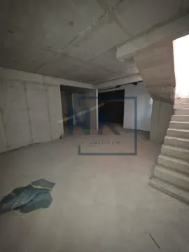 Unfinished space under construction with an interior staircase. - image 10