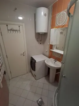 Bathroom with a washbasin, washing machine, water heater and shower cabin. - image 11