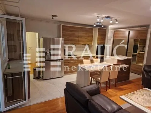 Modern kitchen with dining area and living room in an open space.