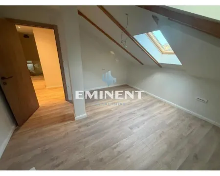 Empty attic room with laminate flooring and a skylight. - image 4