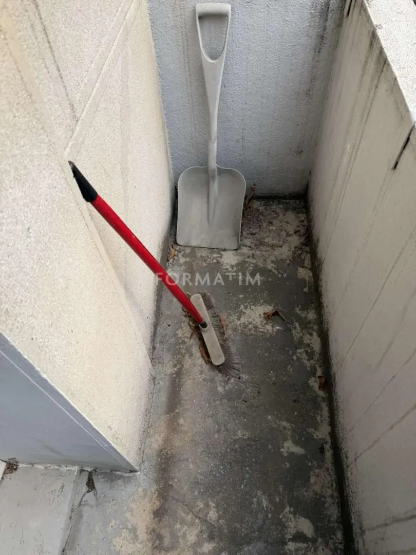 Small balcony with a broom and a shovel.