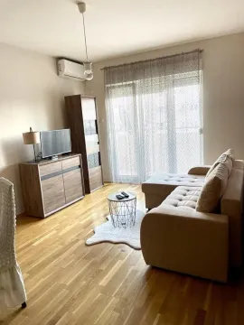 Living room with a sofa, chest of drawers, television, and access to the terrace. - image 2