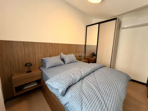 Modern bedroom with a double bed, wardrobe, and nightstands. - image 13