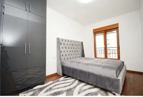Modern bedroom with a double bed, wardrobe, and window. - image 5