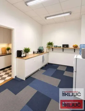 Kitchen with white cabinetry, a wooden countertop, and blue carpet tiles on the floor. - image 3