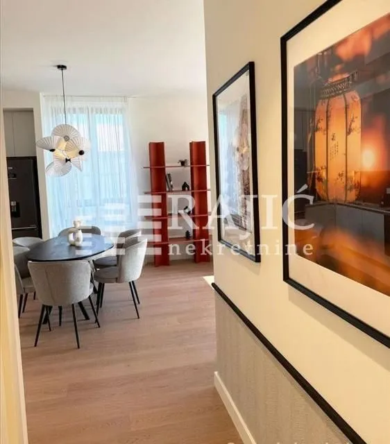 View from the hallway into the dining area with a table and chairs.