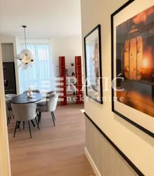 View from the hallway into the dining area with a table and chairs. - image 6