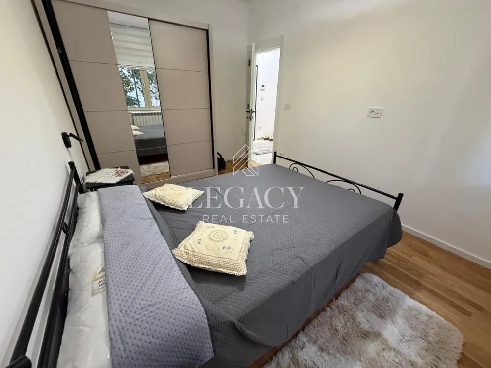 Furnished bedroom with a double bed and wardrobe.