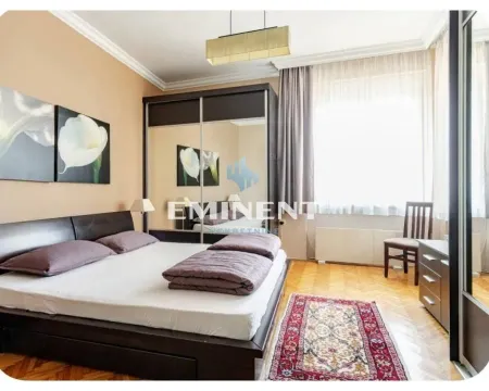 Spacious bedroom with a double bed, large mirrored wardrobe, and parquet flooring. - image 14