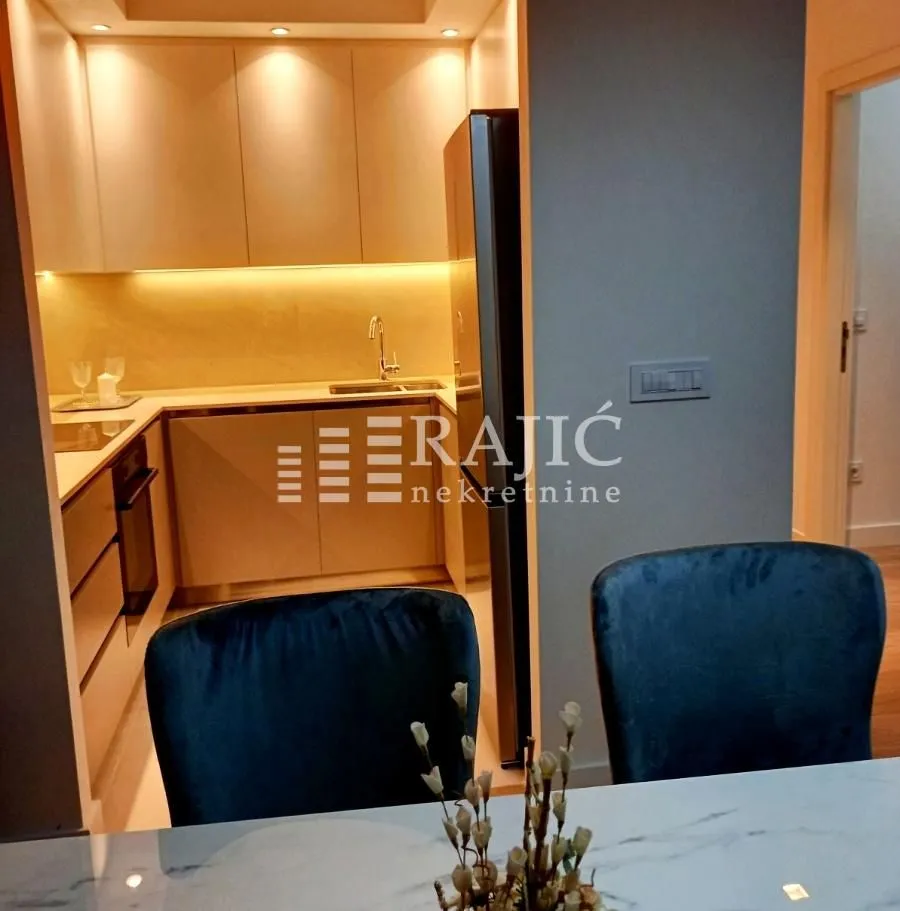Modern kitchen with built-in cabinetry and a dining area in the foreground.