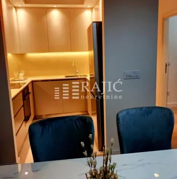 Modern kitchen with built-in cabinetry and a dining area in the foreground. - image 18