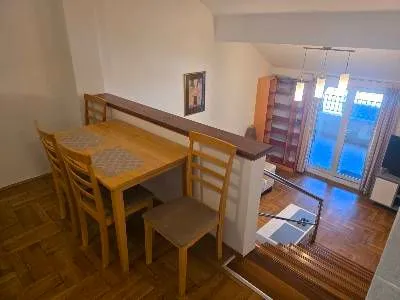 High-angle view of the dining area and living room with stairs. - image 6