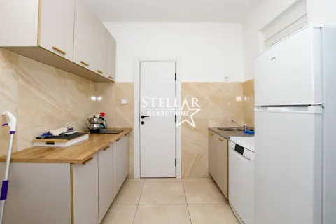 Small kitchen with light-colored cabinets and built-in appliances. - image 3