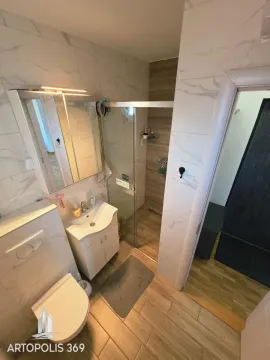 Modernly equipped bathroom with a walk-in shower and washbasin. - image 18