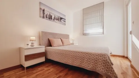A furnished bedroom with a double bed and nightstands. - image 5