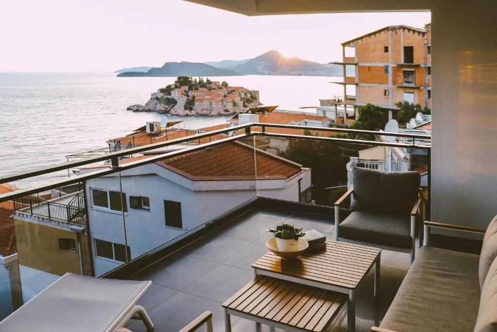 Furnished terrace with lounge furniture and a view of Sveti Stefan.