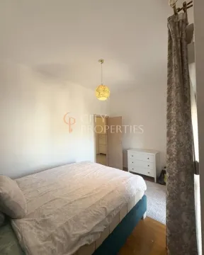 Bedroom with a double bed, white chest of drawers, and an open door. - image 6