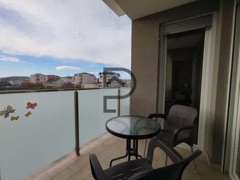 Furnished terrace with a table and chairs and a city view. - image 8