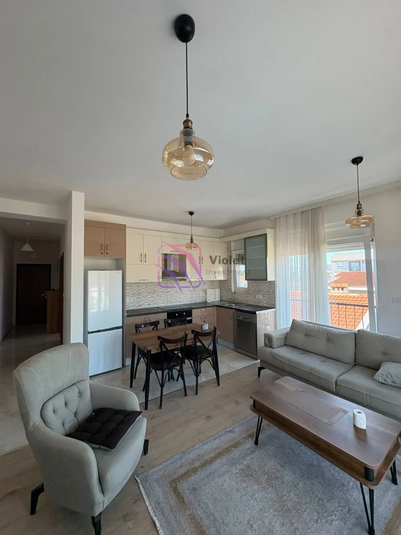 Living room with kitchen and dining area in an open space layout.