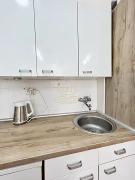 Part of the kitchen with white cabinets, a sink, and a countertop. - image 5