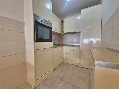 Kitchen with light cabinets and a built-in oven. - image 23