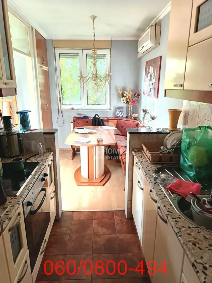 Kitchen with a dining area and fitted cabinets.