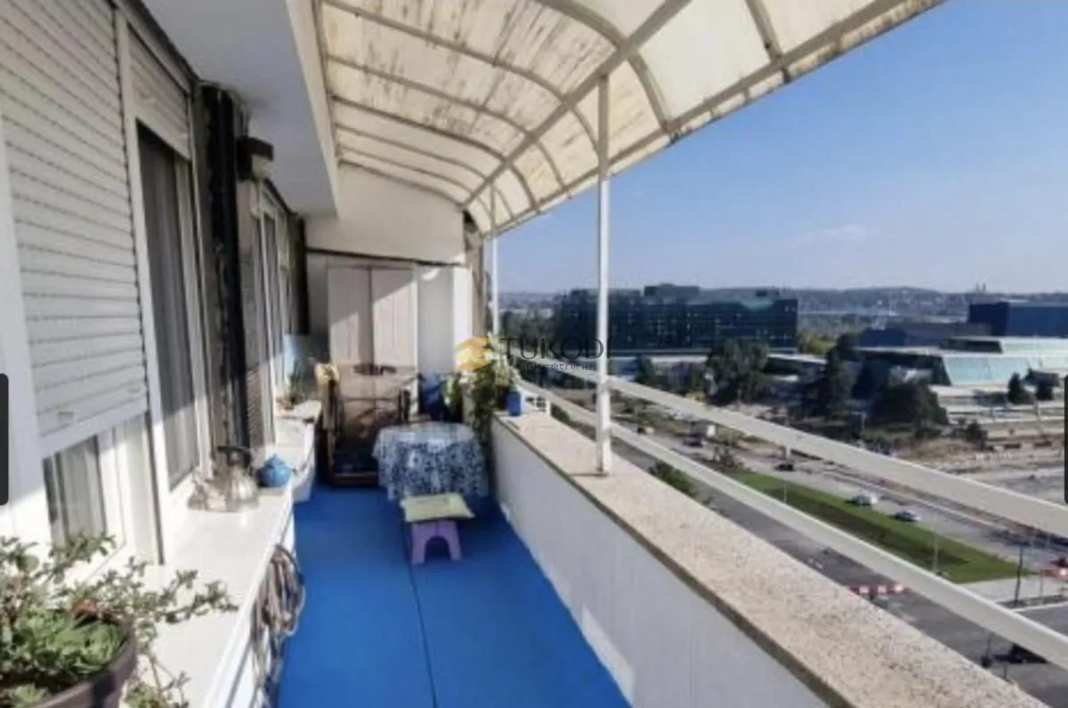 Covered balcony with a view of the city and road.