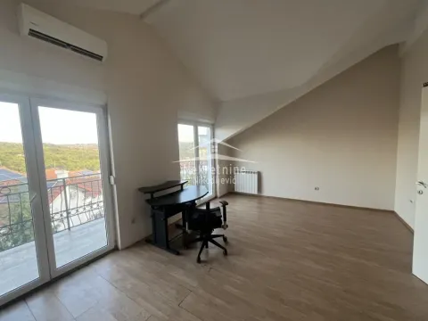 Empty room with a sloped ceiling, a desk, and access to a terrace. - image 6