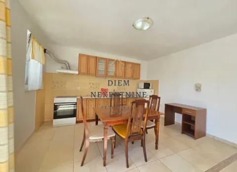 Dining area and kitchen in bright tones with wooden elements. - image 12