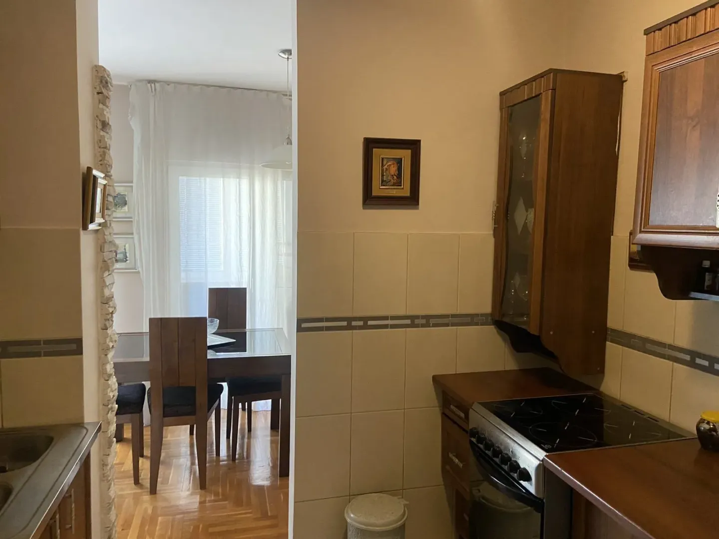 A kitchen with a view of the dining area in the background.