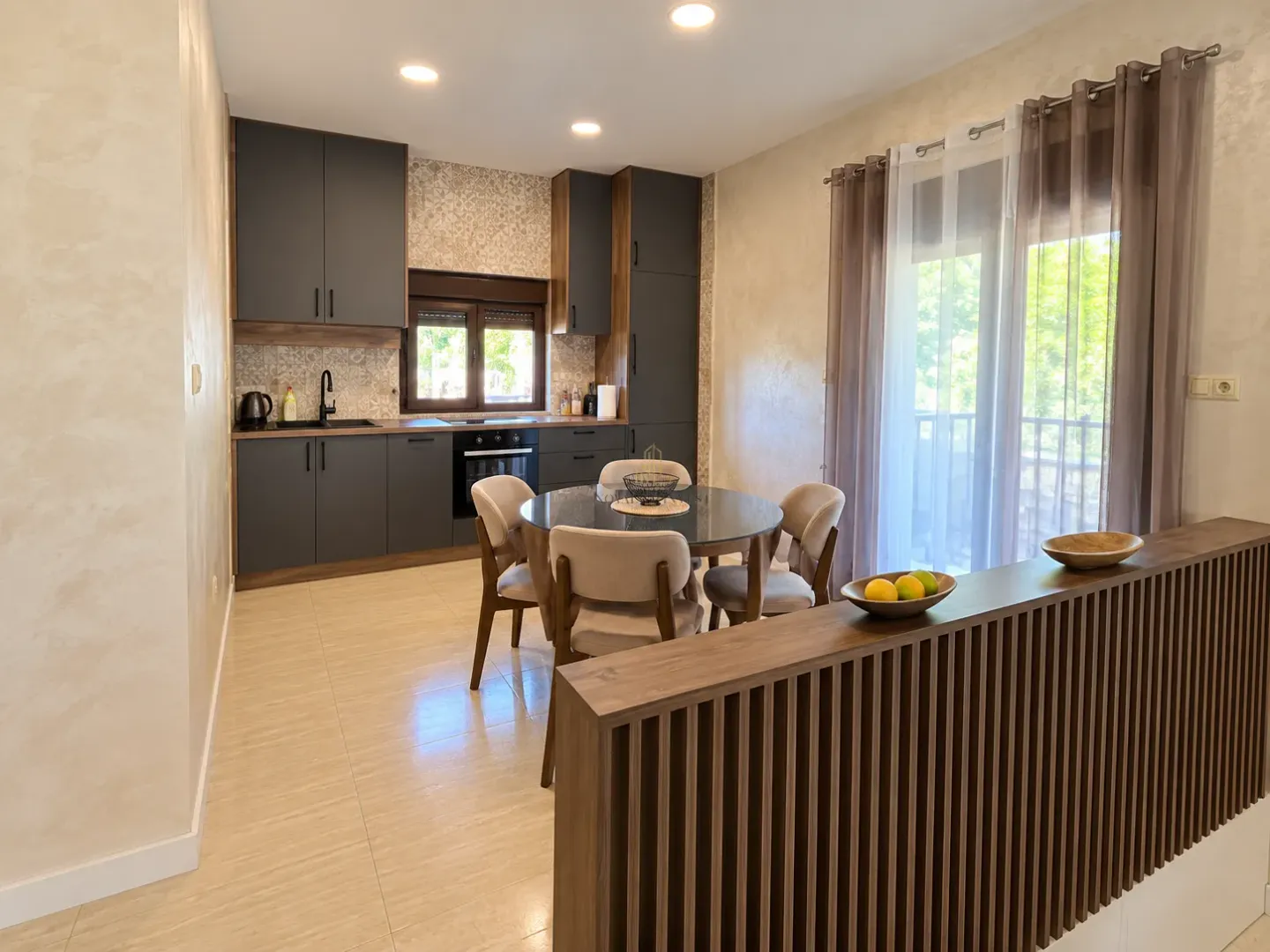 Kitchen with dining area and access to the terrace.