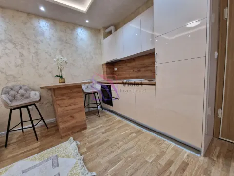 Modern kitchen with built-in units and a dining table with chairs. - image 5