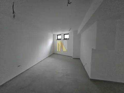 Empty room under construction with white walls and small windows. - image 11