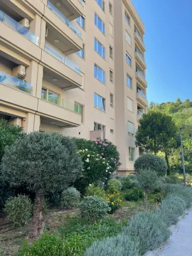 Exterior of the residential building with landscaped courtyard and greenery. - image 17