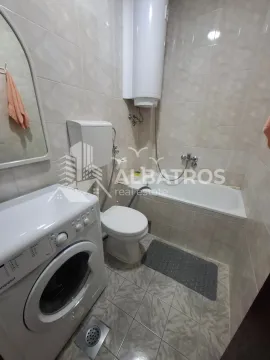 Bathroom equipped with a bathtub, toilet, water heater and washing machine. - image 7
