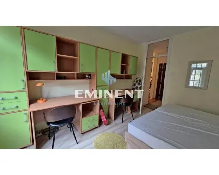 Children's bedroom with a bed, desk, and green wardrobes. - image 9