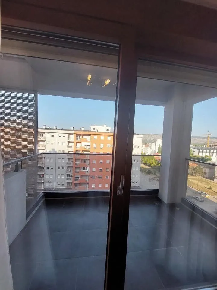 View from the balcony overlooking surrounding buildings and urban landscape.