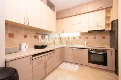Kitchen equipped with wooden cabinetry and built-in home appliances. - image 12