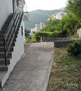 Courtyard of the house with an external staircase and paved area. - image 24