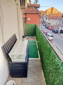 Long balcony with artificial grass and street view. - image 4