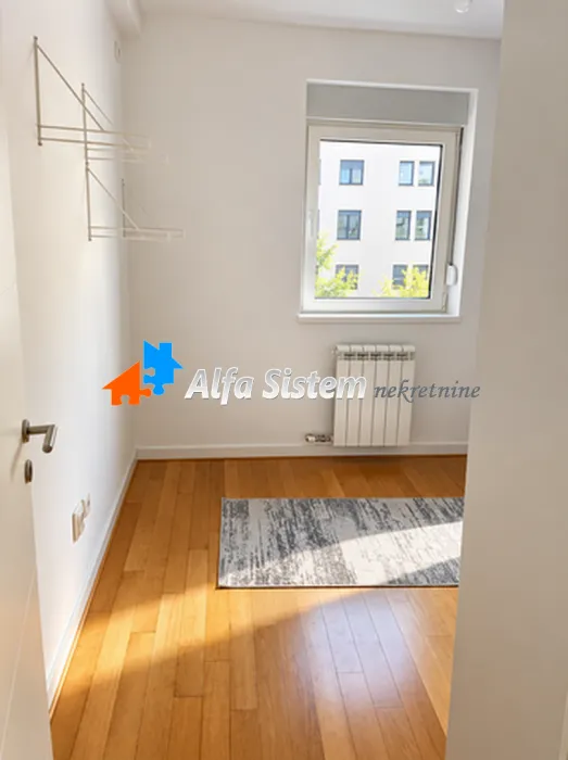 Empty room with hardwood floors and a window.