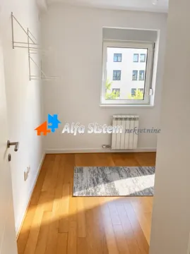 Empty room with hardwood floors and a window. - image 7