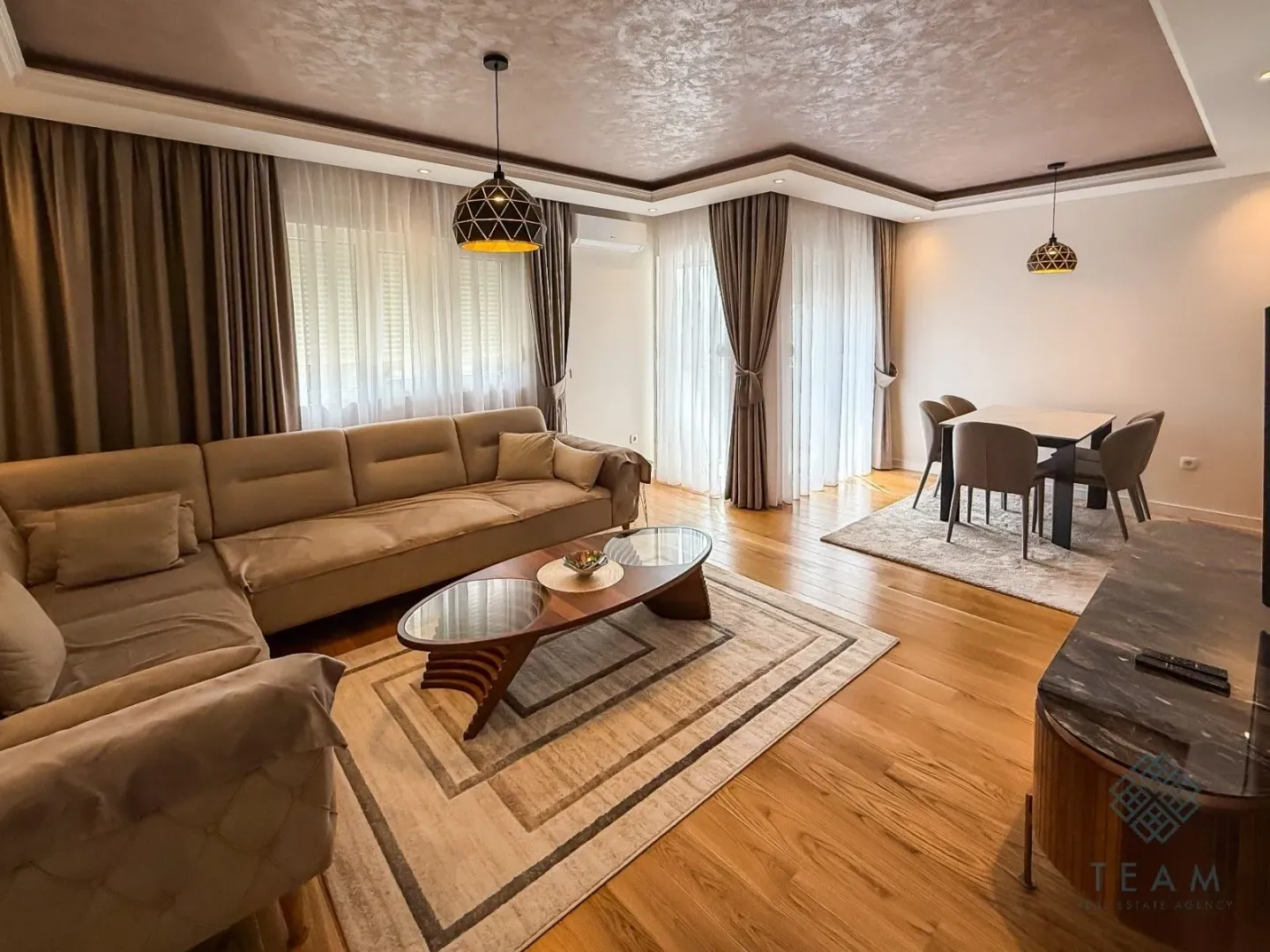 Spacious living room with a sofa set and a dining area.